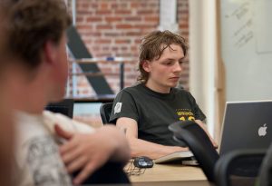 programmer reviewing code on a monitor